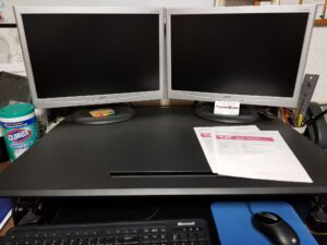An Organized Desk with 2 monitors, keyboard and mouse